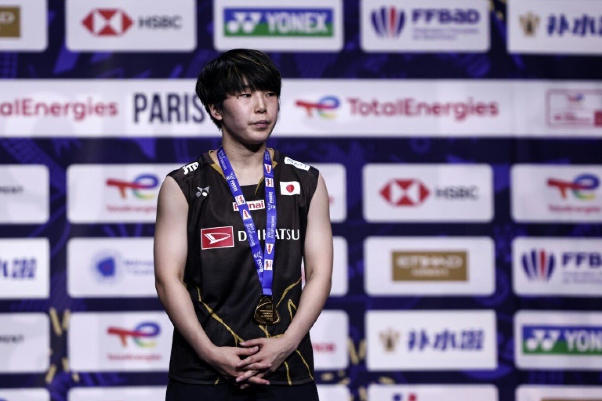 Japan's Akane Yamaguchi wears her gold medal on the podium after beating China's Chen Yufei in the women's singles final