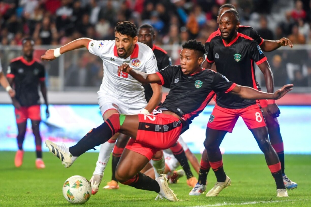 Tunisia forward Hazem Mastouri (L) is surrounded by Malawi defenders during a 2026 World Cup qualifier in Rades.