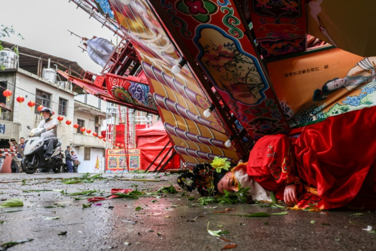 Typhoon Champi dumped heavy rain, toppled trees and structures, and knocked out power to thousands of households as it swept past Taiwan's northeast on the way to China and Japan