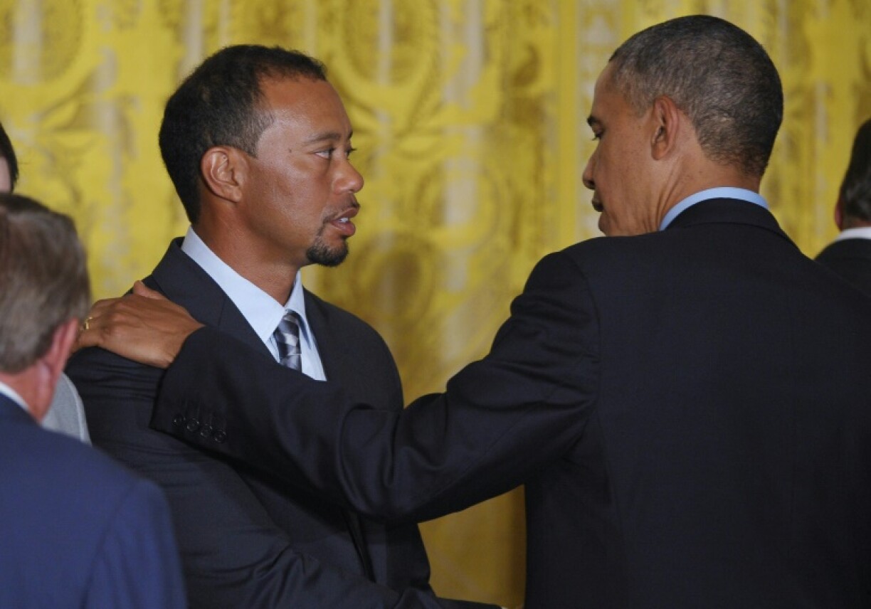 The production company owned by former US president Barack Obama (R) is in talks to produce a new biopic about golf legend Tiger Woods (L)
