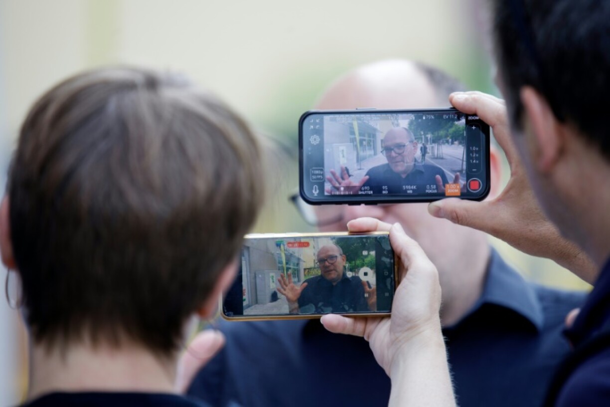 Teacher Paul Nitsche talks to reporters near the school in Graz