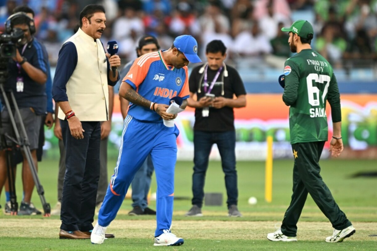 India captain Suryakumar Yadav (C) walks away without shaking hands with Pakistan counterpart Salman Agha (R) after the toss for the start of the Asia Cup Super Four contest in Dubai on Sunday