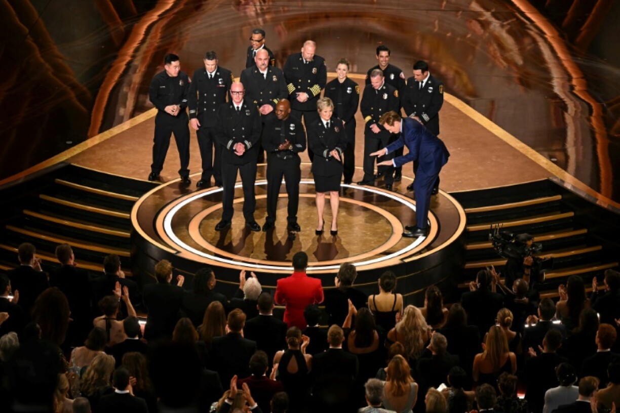 (From L) Los Angeles Fire Department (LAFD) Captain Erik Scott, LAFD helicopter pilot Jonith Johnson Jr. and Pasadena Fire Captain Jodi Slicker speak alongside comedian and host Conan O'Brien during the 97th Annual Academy Awards