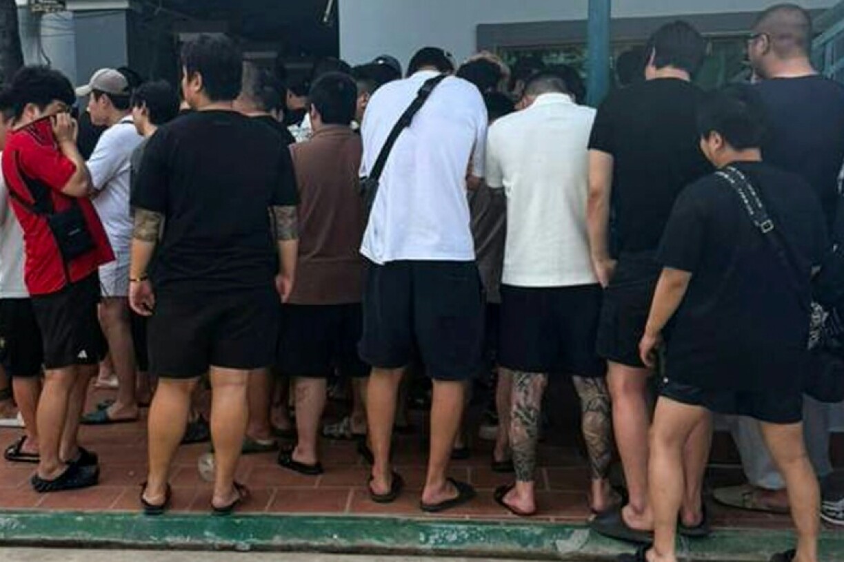 A handout photo from Agence Kampuchea Press taken on October 22 and released on October 23 shows South Koreans suspected of being involved in cyberscams, detained during a raid in Phnom Penh