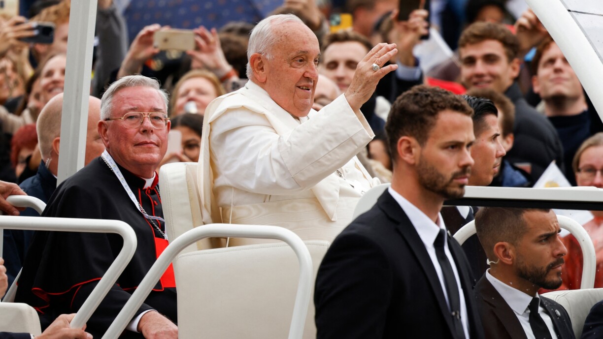 Pope Francis and Cardinal Jean-Claude Hollerich riding through Luxembourg City in the Popemobile.