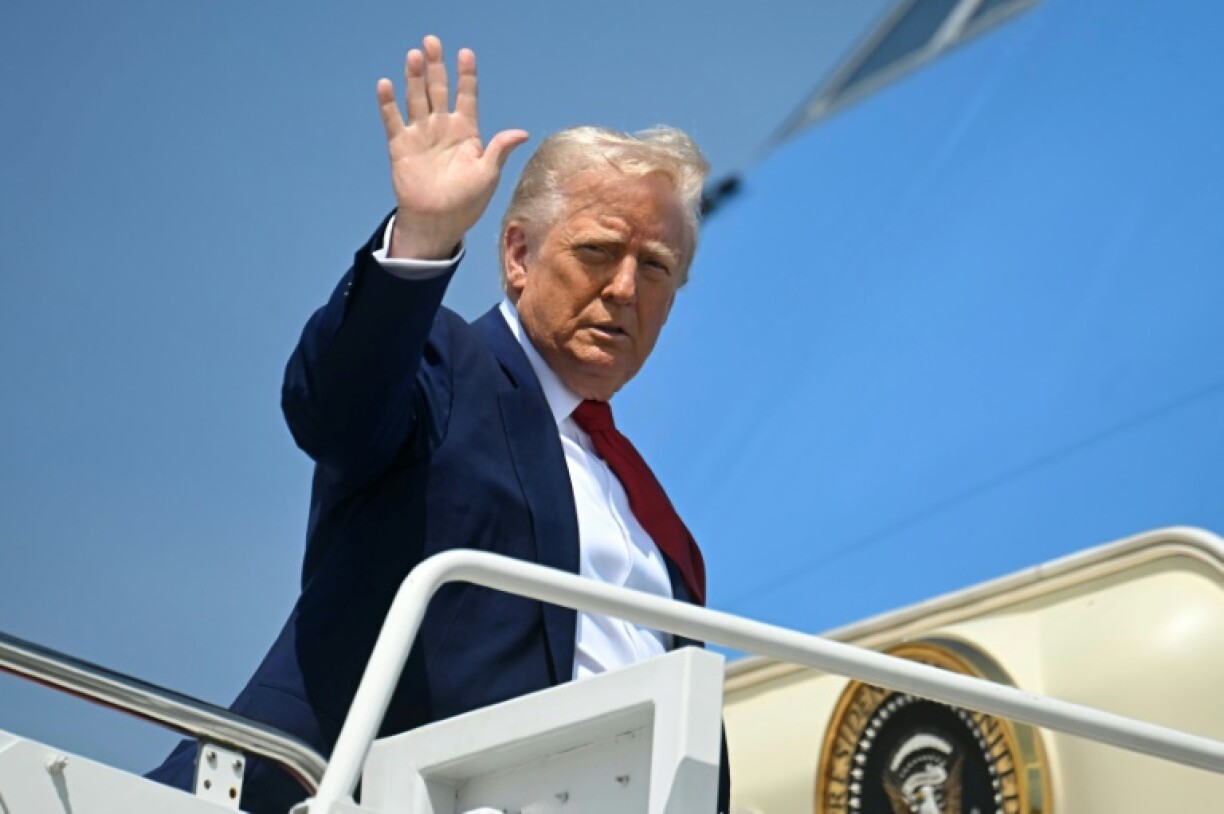 US President Donald Trump waves as he boards Air Force One at Joint Base Andrews in Maryland on April 29, 2025 as he departs for a rally in Michigan to mark his 100th day in office.