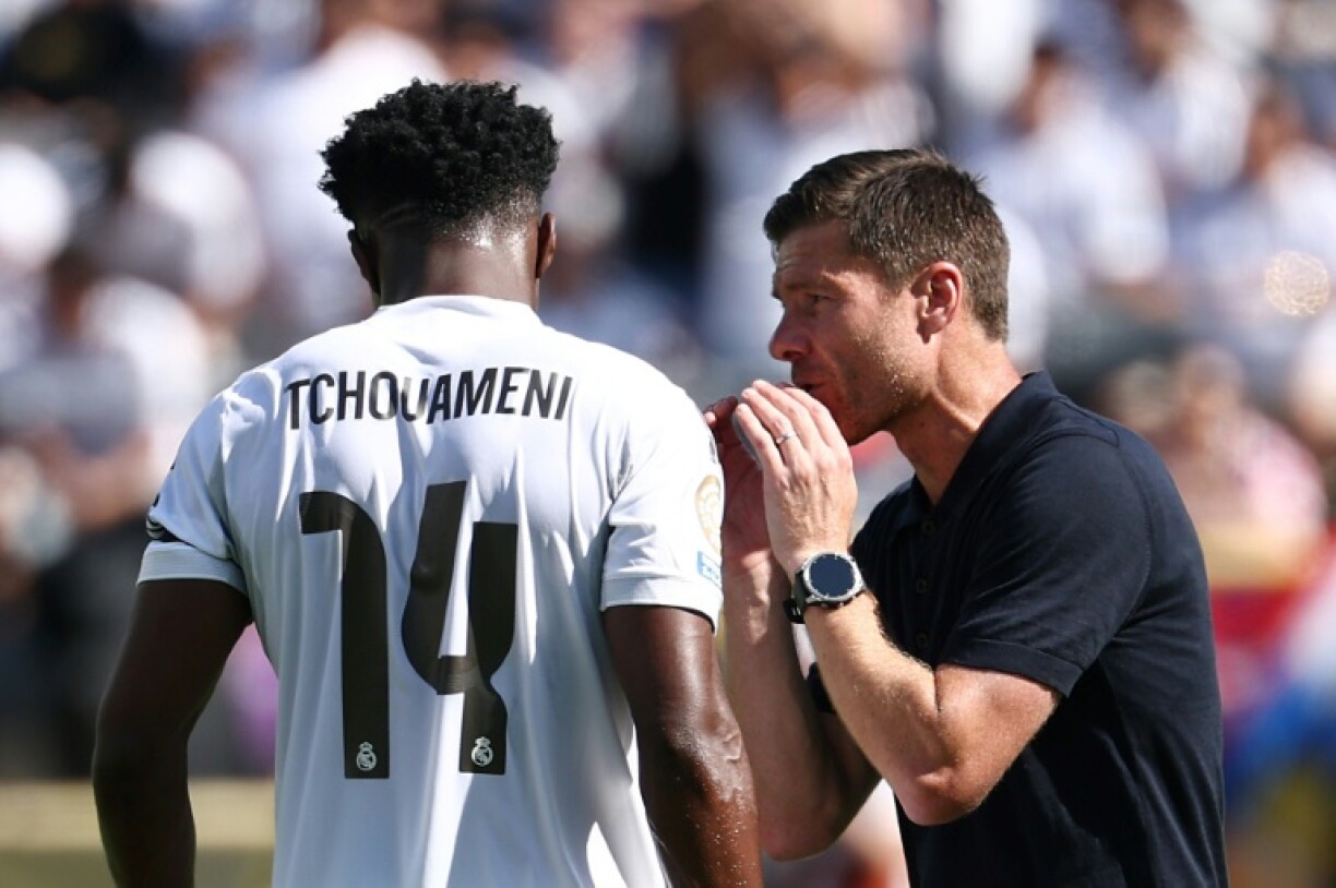 Real Madrid coach Xabi Alonso gives instructions to midfielder Aurelien Tchouameni during the Club World Cup quarter-final against Borussia Dortmund