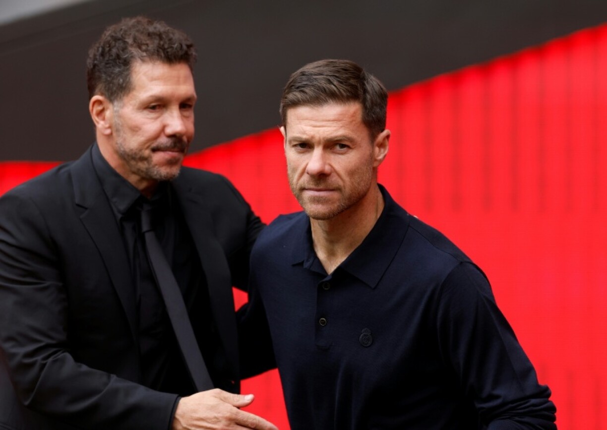 Real Madrid's Spanish coach Xabi Alonso (R) admitted his team deserved to lose the derby clash against Atletico Madrid led by Diego Simeone (L)