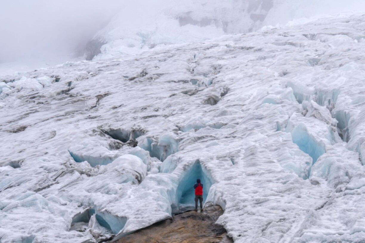 A tourist explores the Ritacuba Blanco glacier at the Natural National Park Nevado El Cocuy in Boyaca Department, Colombia, on April 19, 2024