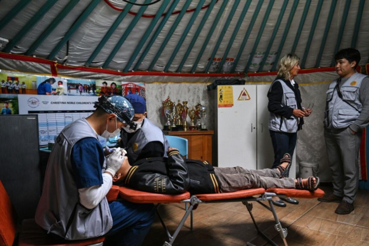 A dentist checks a child's teeth at a mobile dental clinic inside a traditional Mongolian ger in Ulaanbaatar