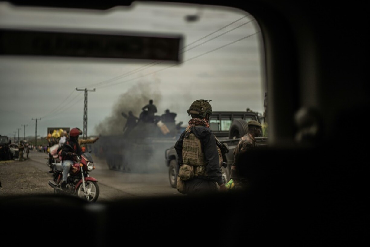 Soldiers of the armed forces of the Democratic republic of Congo ride on top of a tank as they advance towards Sake, 25km northwest of Goma, on January 23, 2025
