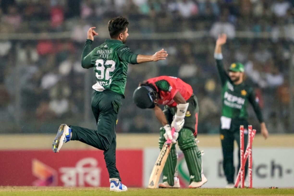 Pakistan's Salman Mirza (L) celebrates after the wicket of Bangladesh's Jaker Ali