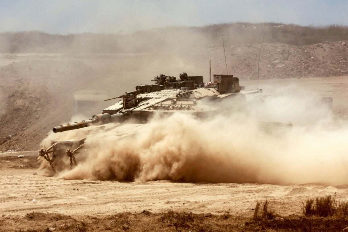 An Israeli tank moves into position along the border with the Gaza Strip