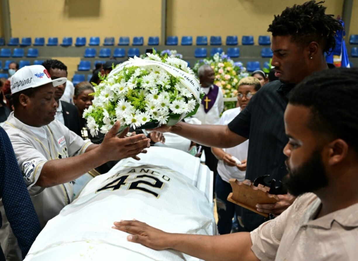 Relatives and friends mourn at the coffin of Dominican former baseball player Tony Blanco, who died in the Jet Set nightclub roof collapse in Santo Domingo, during a memorial ceremony for several victims
