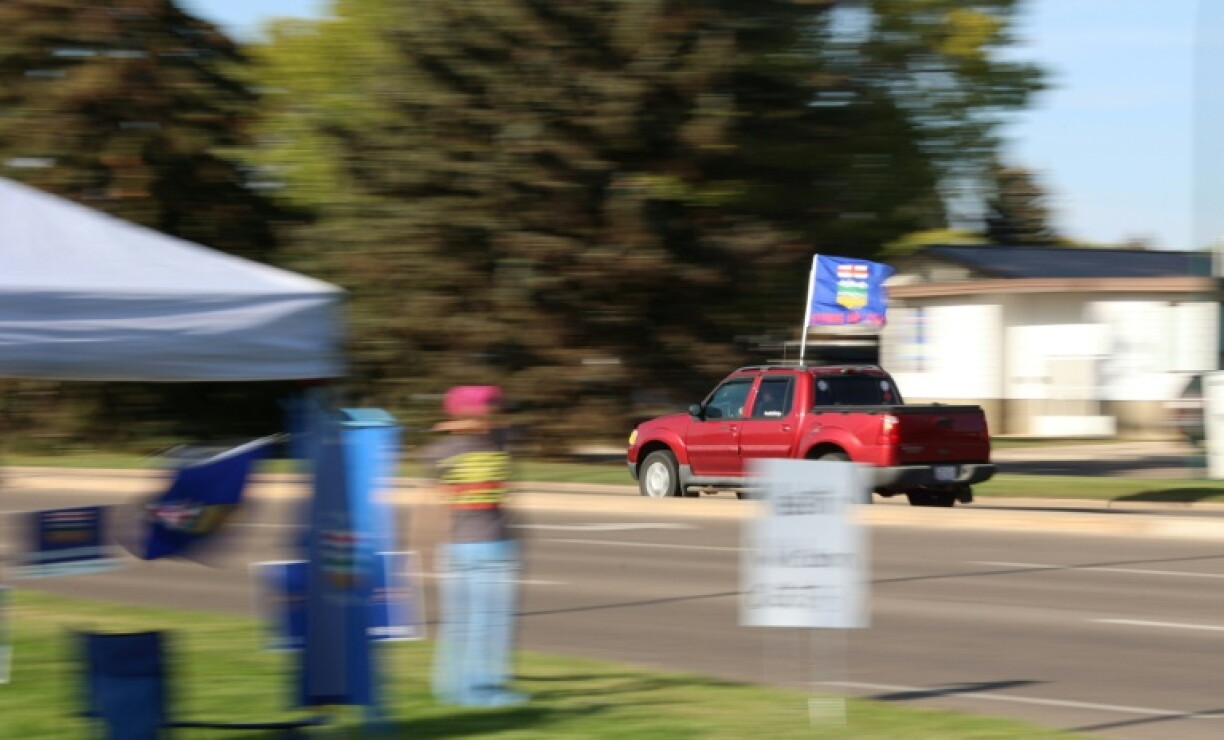 A car flying the Alberta flag circles a separatist event in Medicine Hat, Alberta, on September 23, 2026.