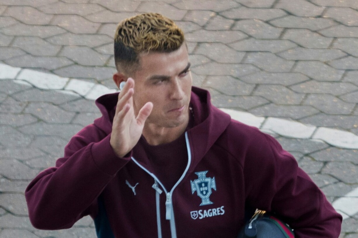 Cristiano Ronaldo waves as he arrives for a training session with the Portugal team at the Parken stadium in Copenhagen on Wednesday. He walked out on the squad shortly after.