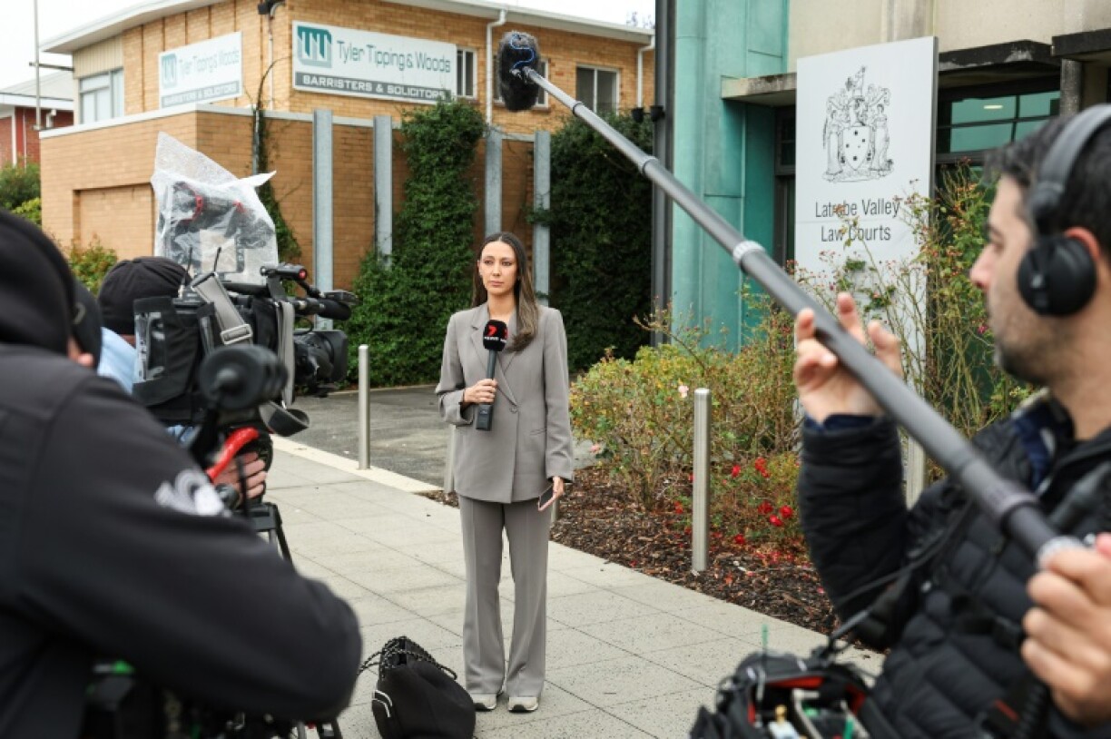 Journalists outside the Latrobe Valley Magistrates' Court building in Morwell, where an Australian woman is charged of murdering three people with a toxic meal. She has denied all charges.