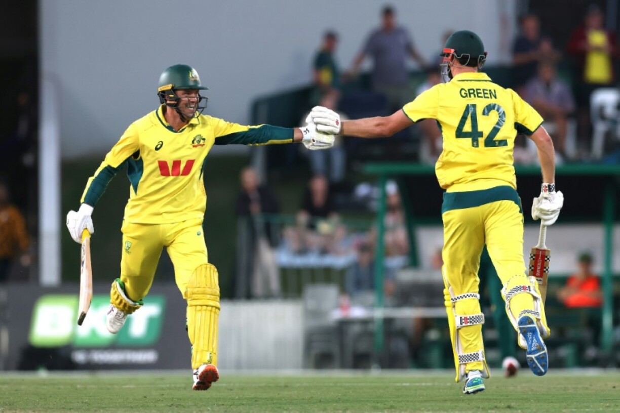 Australia’s Cameron Green (R) reacts with teammate Alex Carey after reaching his century during the third ODI against South Africa