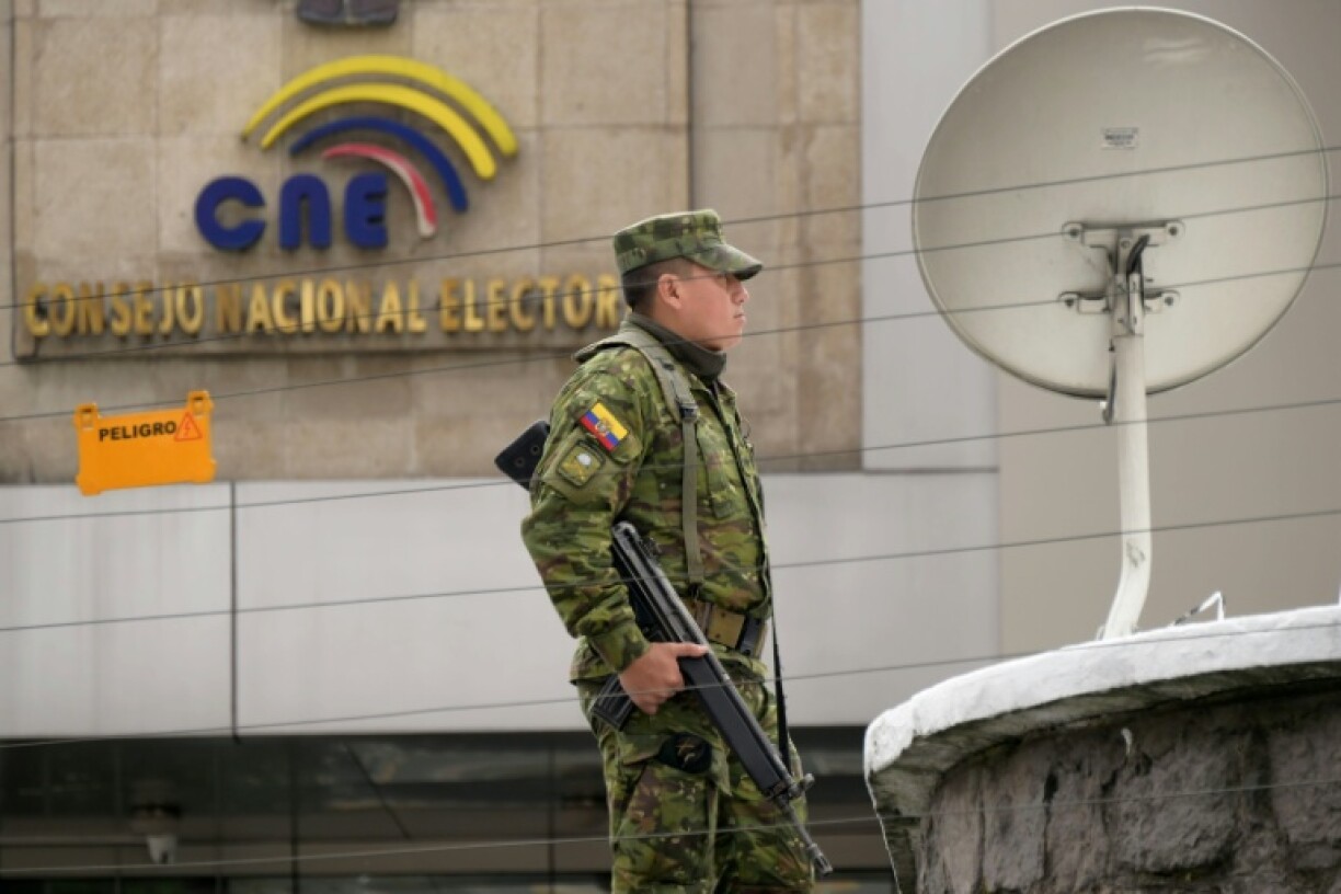A soldier stands guard outside the National Electoral Council (CNE) in Quito on February 7, 2025