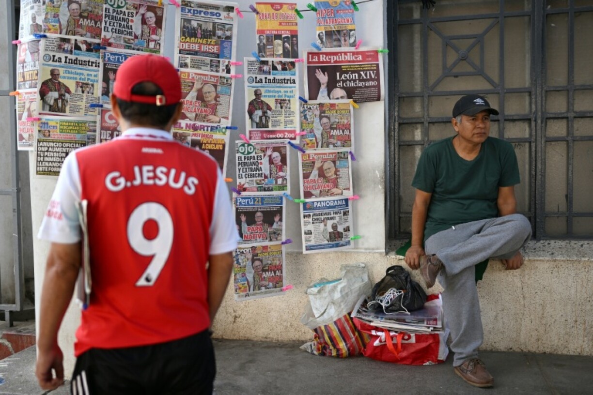 A man looks at the newspapers near Chiclayo's cathedral, northern Peru on May 9, 2025.