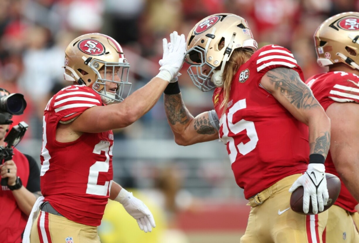 Christian McCaffrey (left) celebrates with San Francisco 49ers team-mate George Kittle after scoring a touchdown in a win over the Washington Commanders