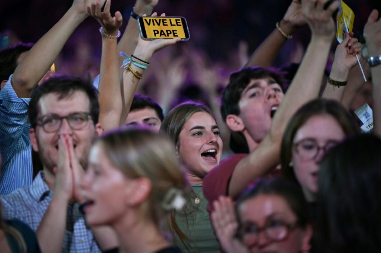 Crowds of mostly young worshppers welcomed the pontiff to an evening vigil at a stadium outside Paris