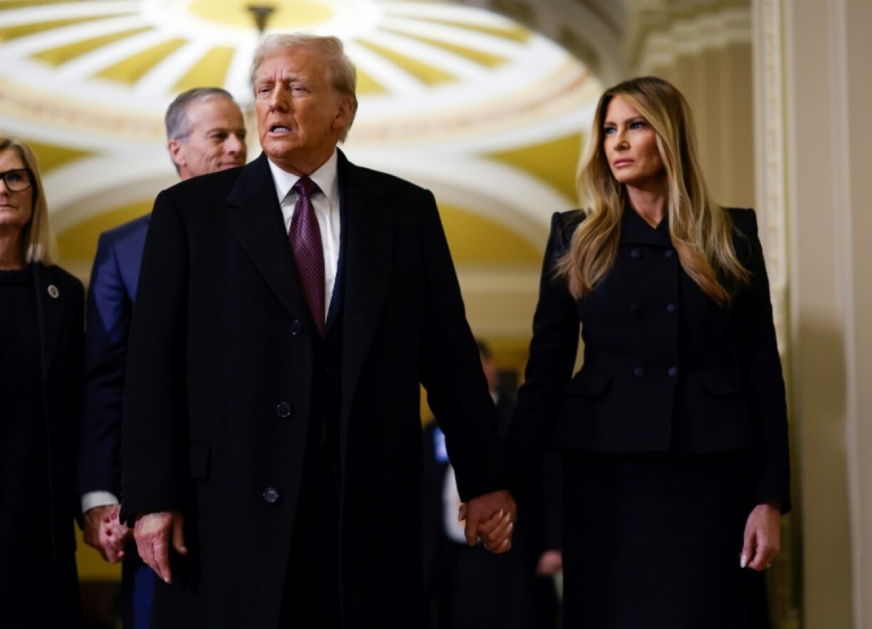 US President-elect Donald Trump and former US First Lady Melania Trump arrive to pay their respects in front of the flag-draped casket of former President Jimmy Carter at the US Capitol Rotunda on January 8, 2025