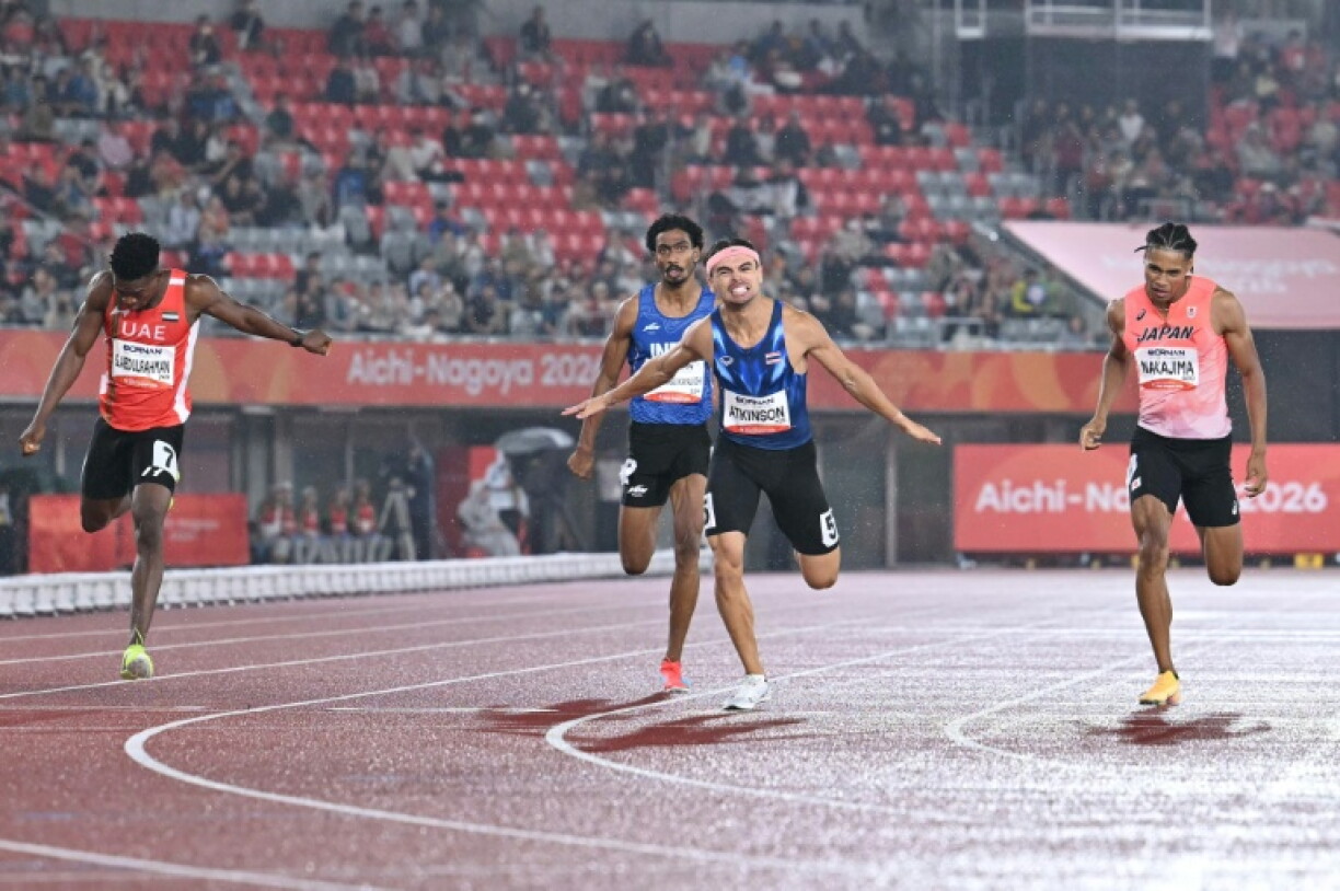 Thailand's Joshua Atkinson (2nd right) wins gold in the men's 400m in front of large sections of empty seats in the background at the Nagoya City Mizuho Park Athletic Stadium