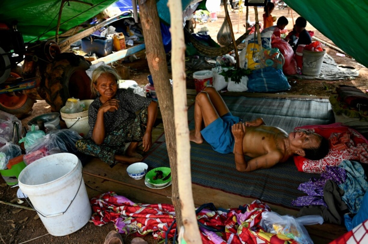 People who fled their homes near the border between Cambodia and Thailand rest in a makeshift shelter