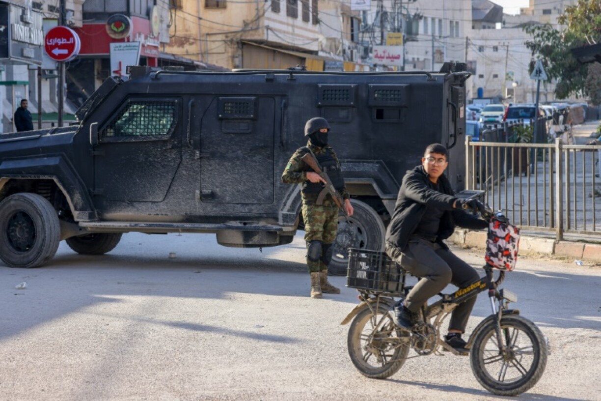 Palestinian security forces man a roadblock in the Israeli-occupied West Bank city of Jenin on December 6, 2024