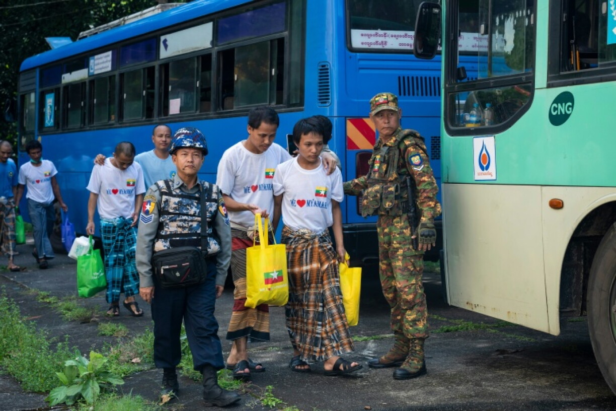 Myanmar migrants repatriated from Malaysia arrive during their official welcoming process in Thanlyin