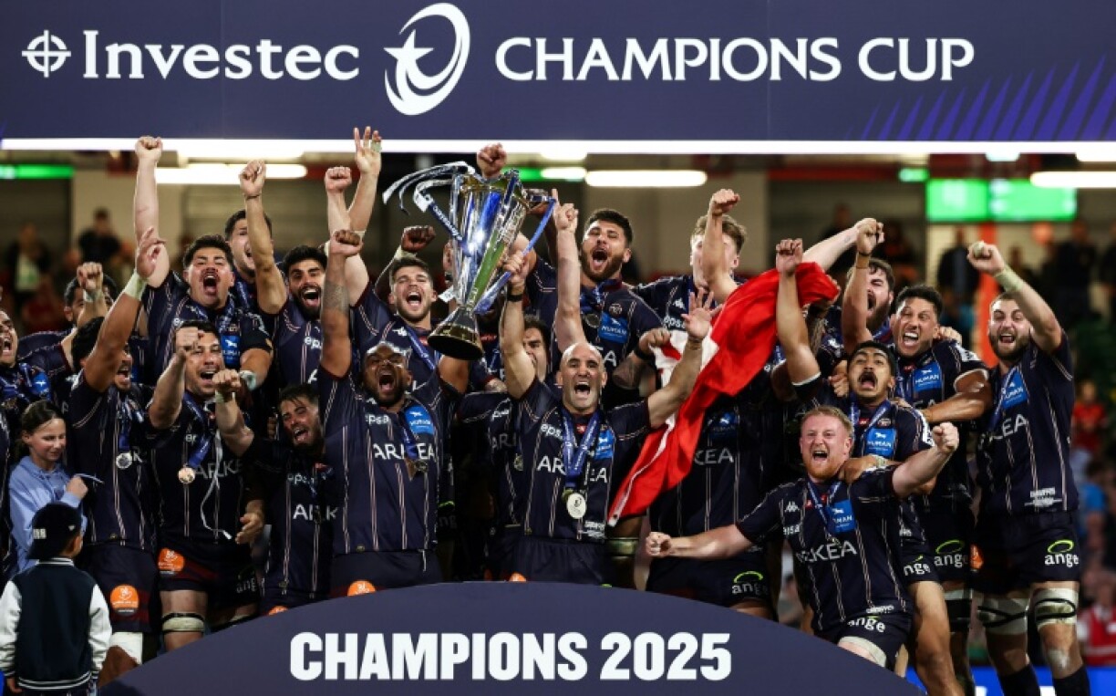 Bordeaux-Begles's players lift the Champions Cup trophy in May