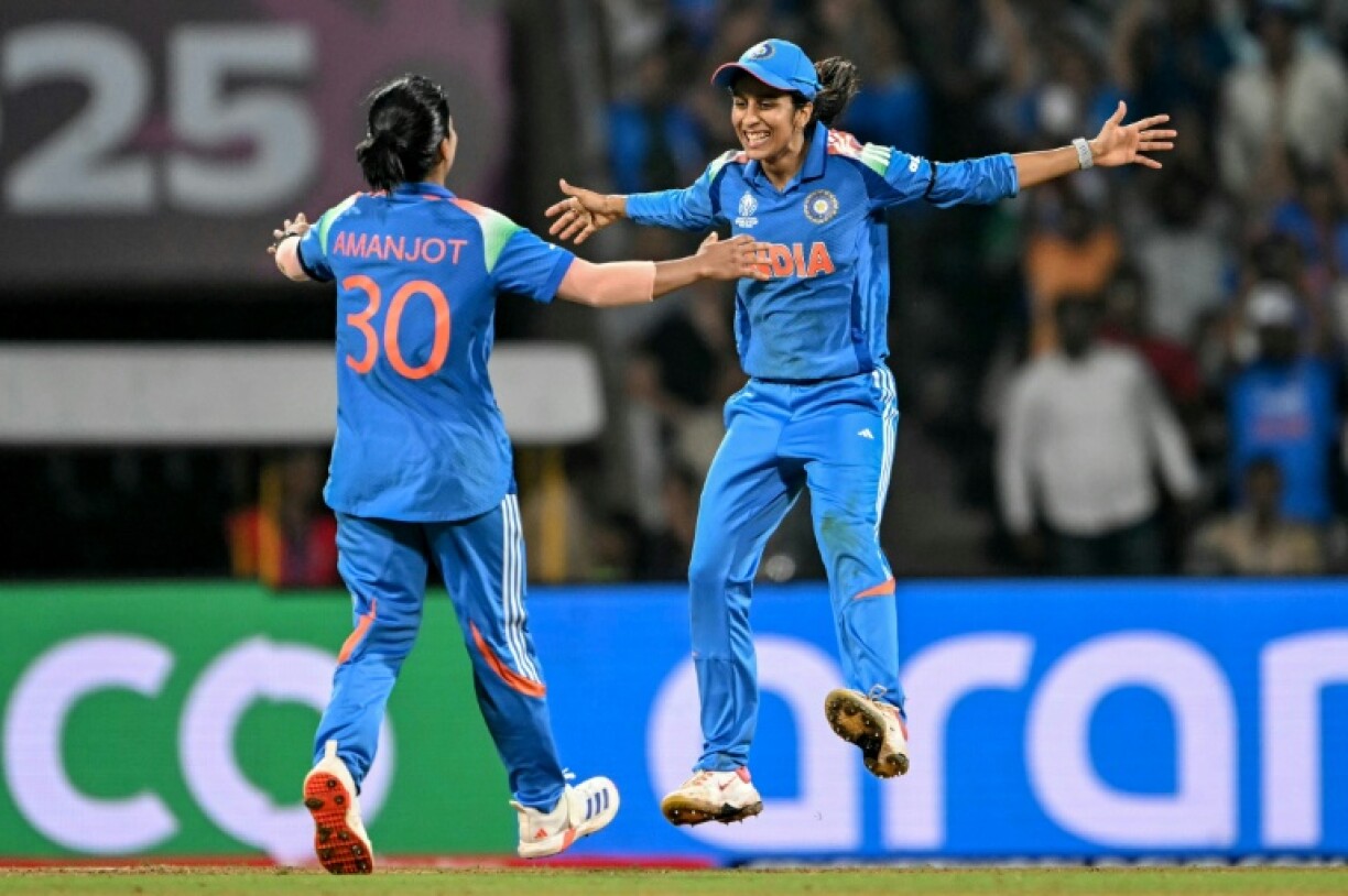 India's Jemimah Rodrigues (R) celebrate with teammate Amanjot Kaur after the dismissal of Australia's Tahlia McGrath
