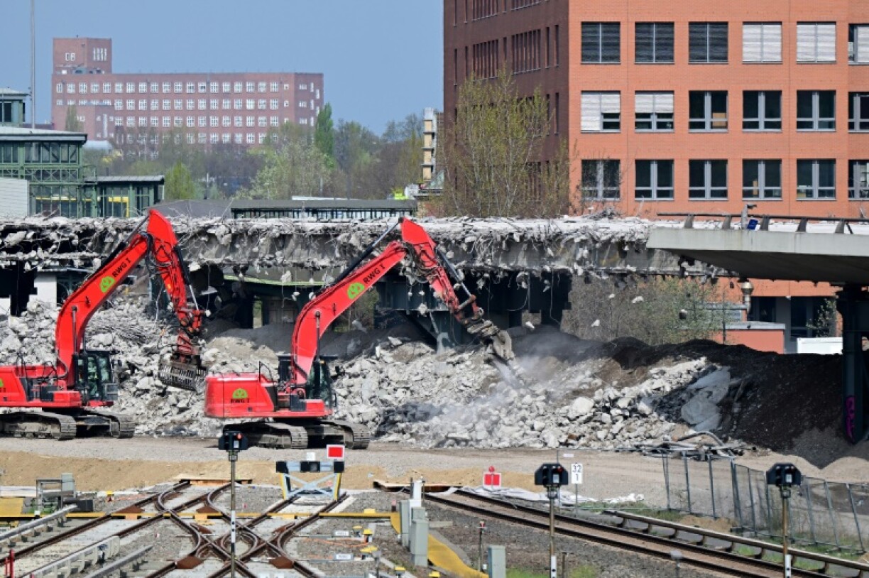 Excavators demolish a section of the 'Ringbahn' bridge of the A100 motorway over the tracks of the suburban S-Bahn train in Berlin