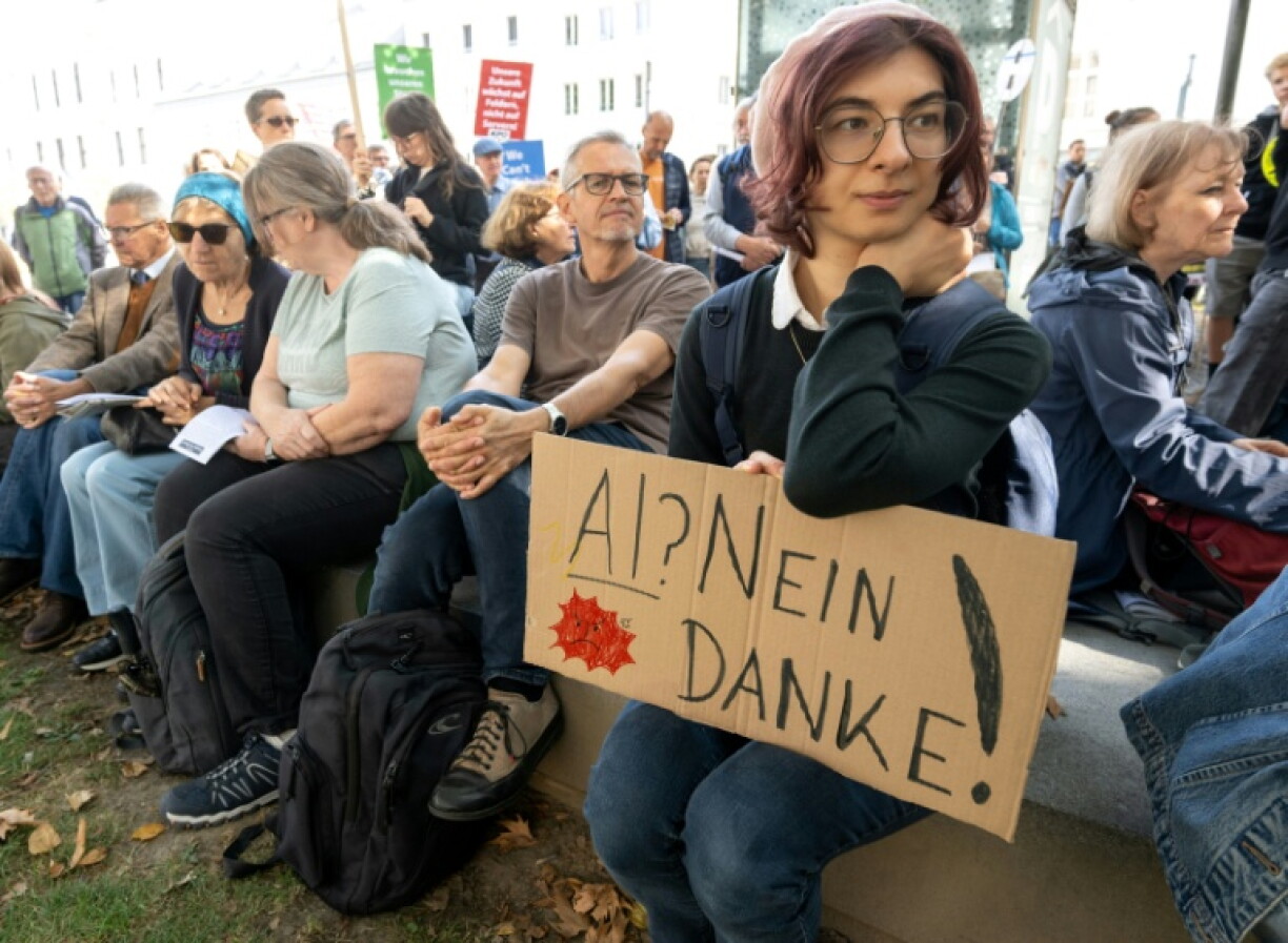 Protesters around the world -- seen here with a sign that reads 'AI? No thanks!' in Linz, Austria -- have voiced opposition to new data centers and their heavy demand on resources, as well as the use of AI in public surveillance and warfare
