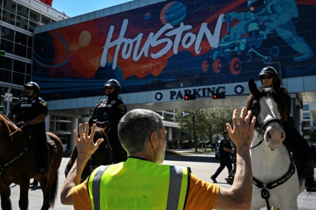 Demonstrators protest against the Ceraweek by S&P Global energy conference, near the hotel where the conference is being attended, in Houston, Texas, on March 10, 2025