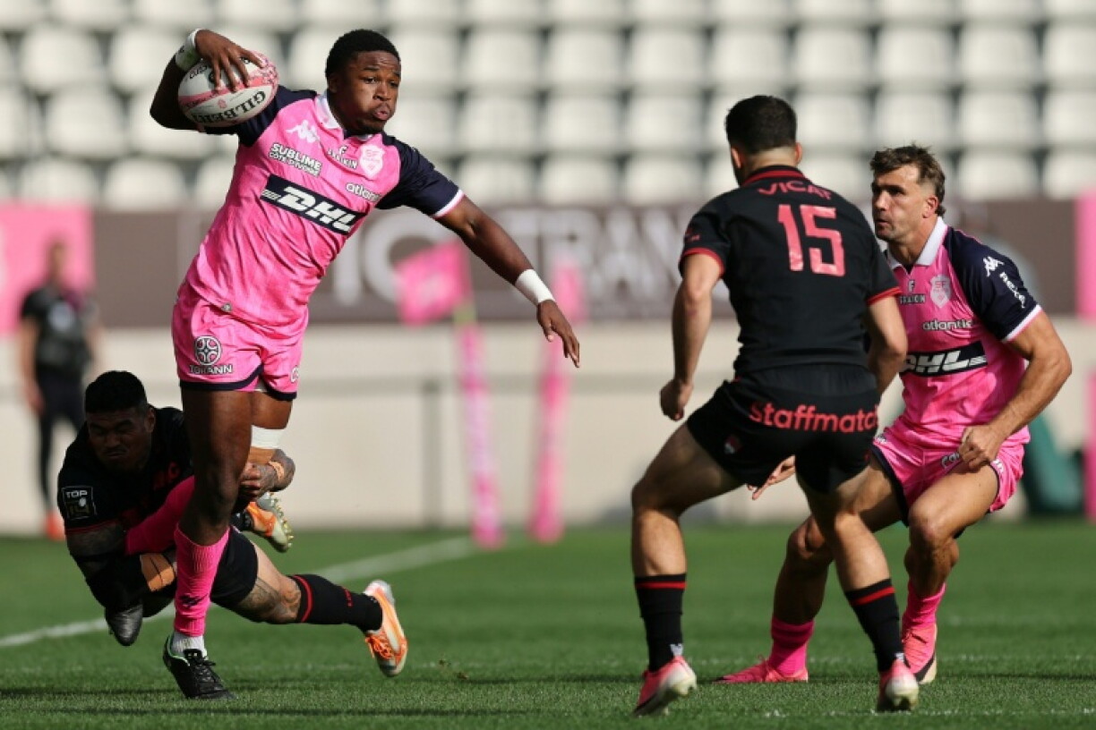Stade Français wing Samuel Ezeala is tackled by Lyon wing Monty Ioane