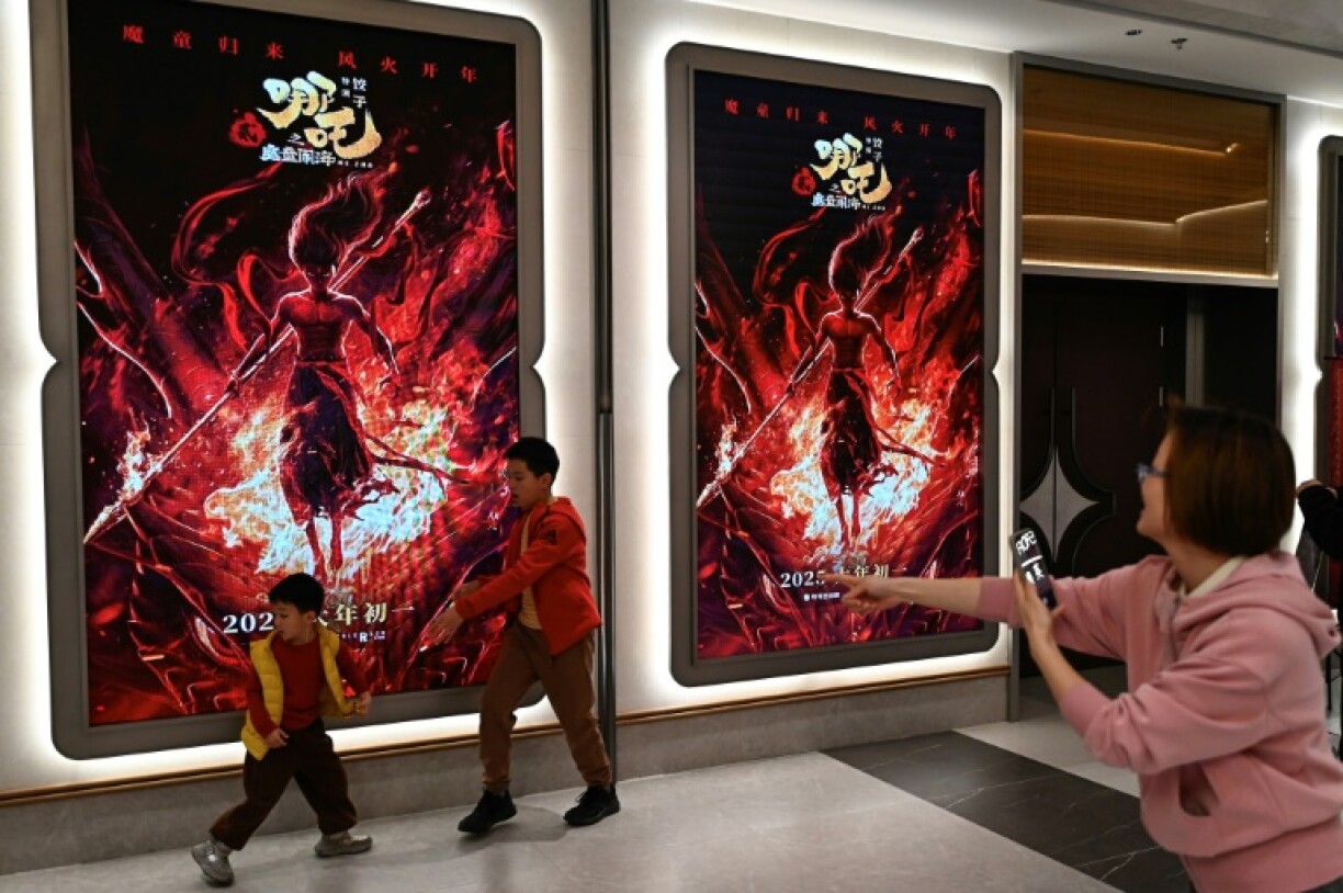 Chinese fans of blockbuster film 'Ne Zha 2' pack into cinemas in Beijing, snapping selfies and queueing up for movie posters and other merchandise