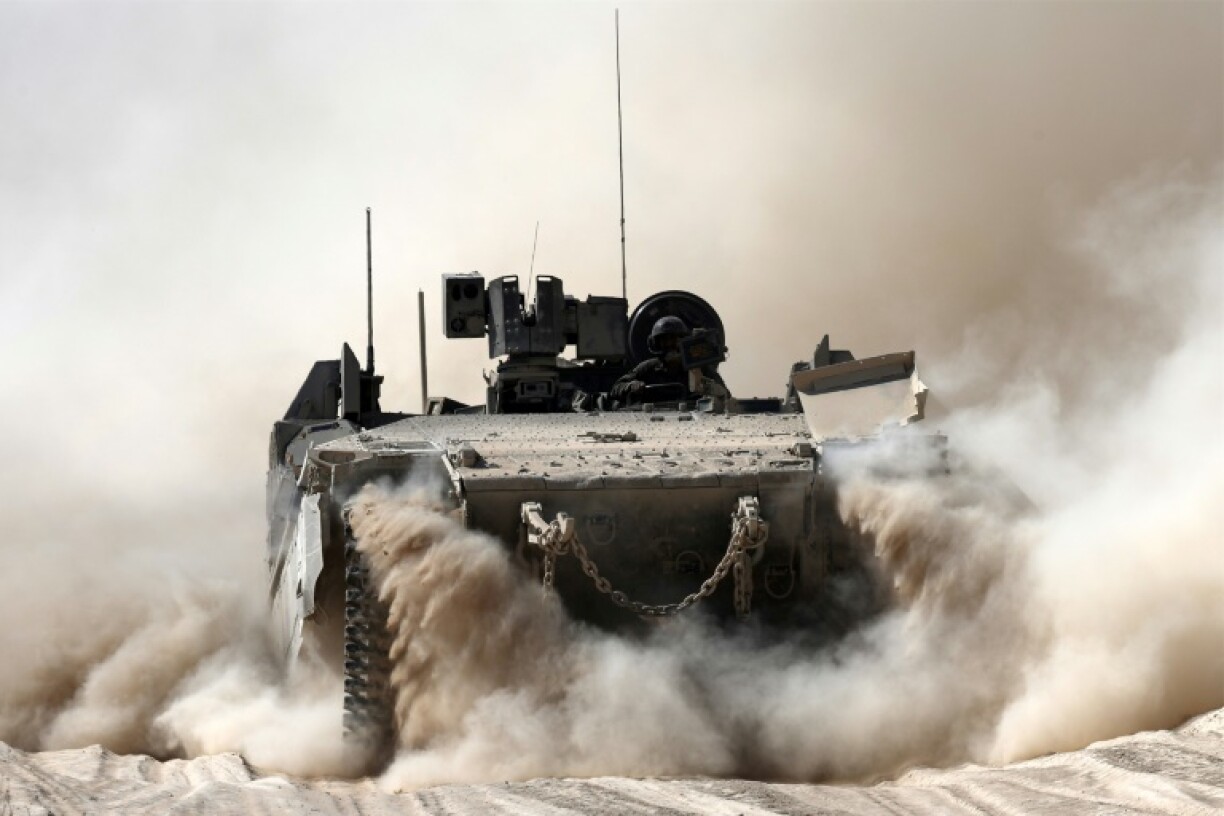 An Israeli armoured personnel carrier moves along the border with the Gaza Strip.