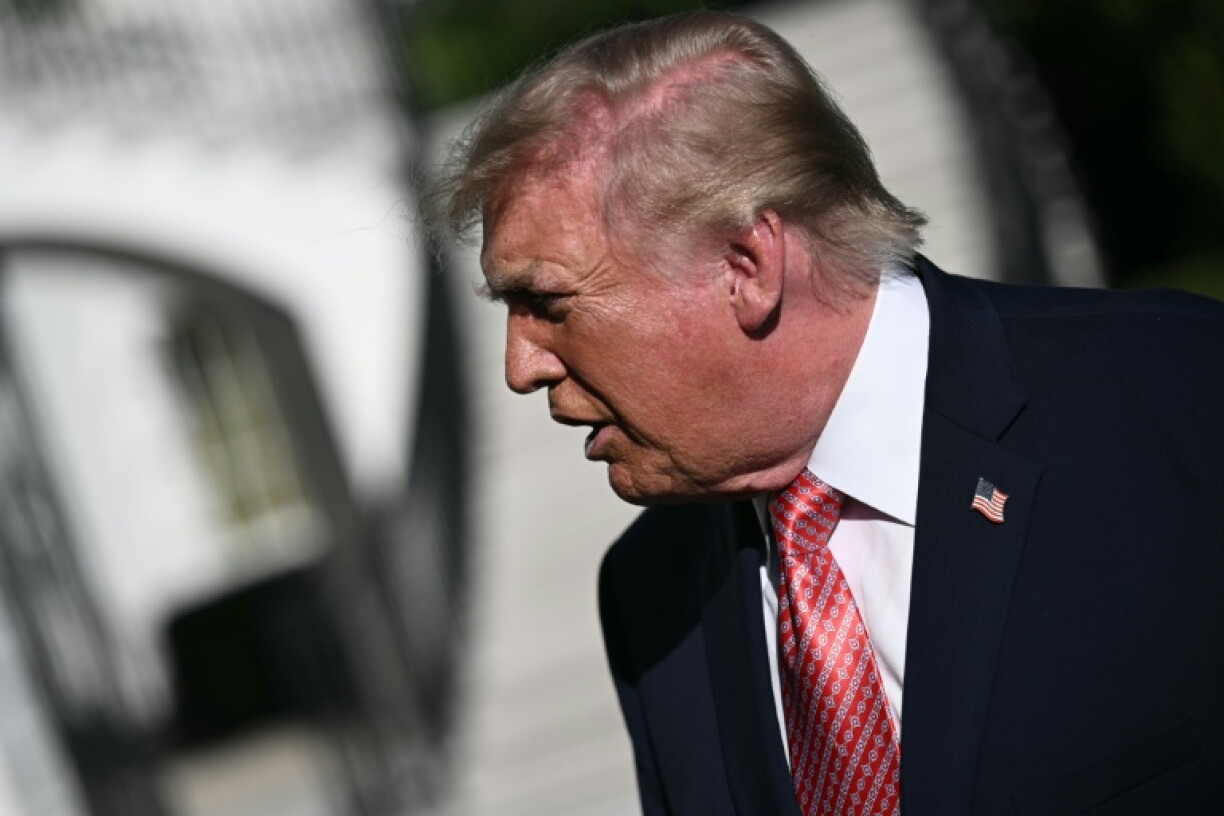 US President Donald Trump speaks to members of the press before boarding Marine One on the South Lawn of the White House
