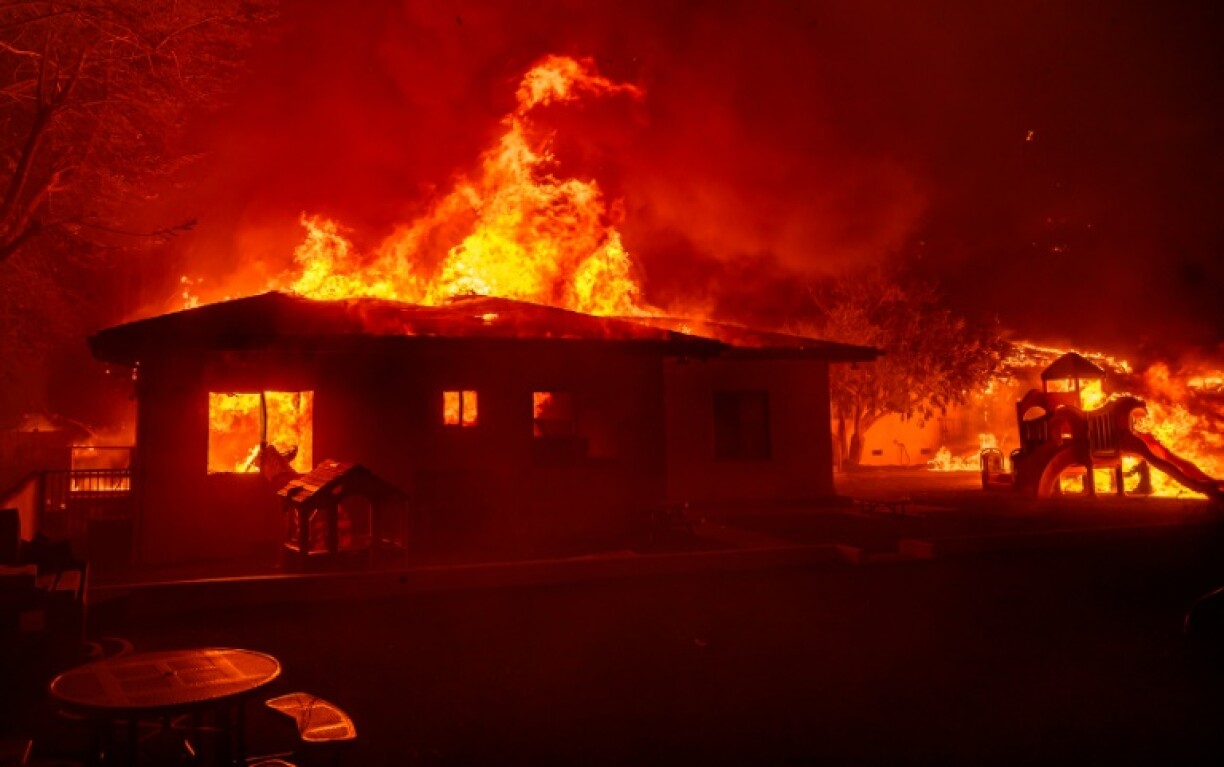 A ferocious wildfire in a Los Angeles suburbs devoured buildings and sparked panicked evacuations