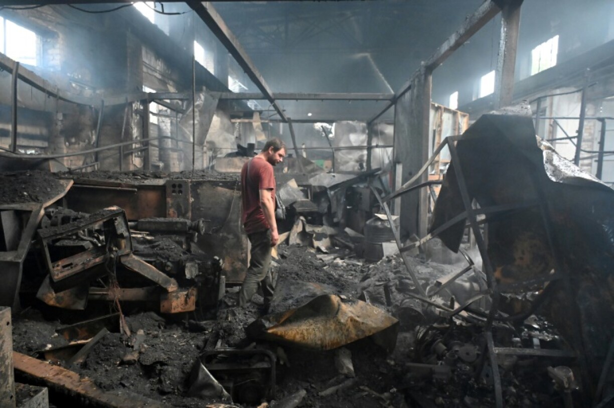 A man stands in a damaged building following an air attack in Kharkiv, Ukraine's second-largest city