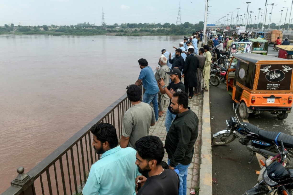 Pakistan authorities blew up an embankment next to a flood-swollen dam during a brutal monsoon season, with a holy Sikh site submerged by floodwater