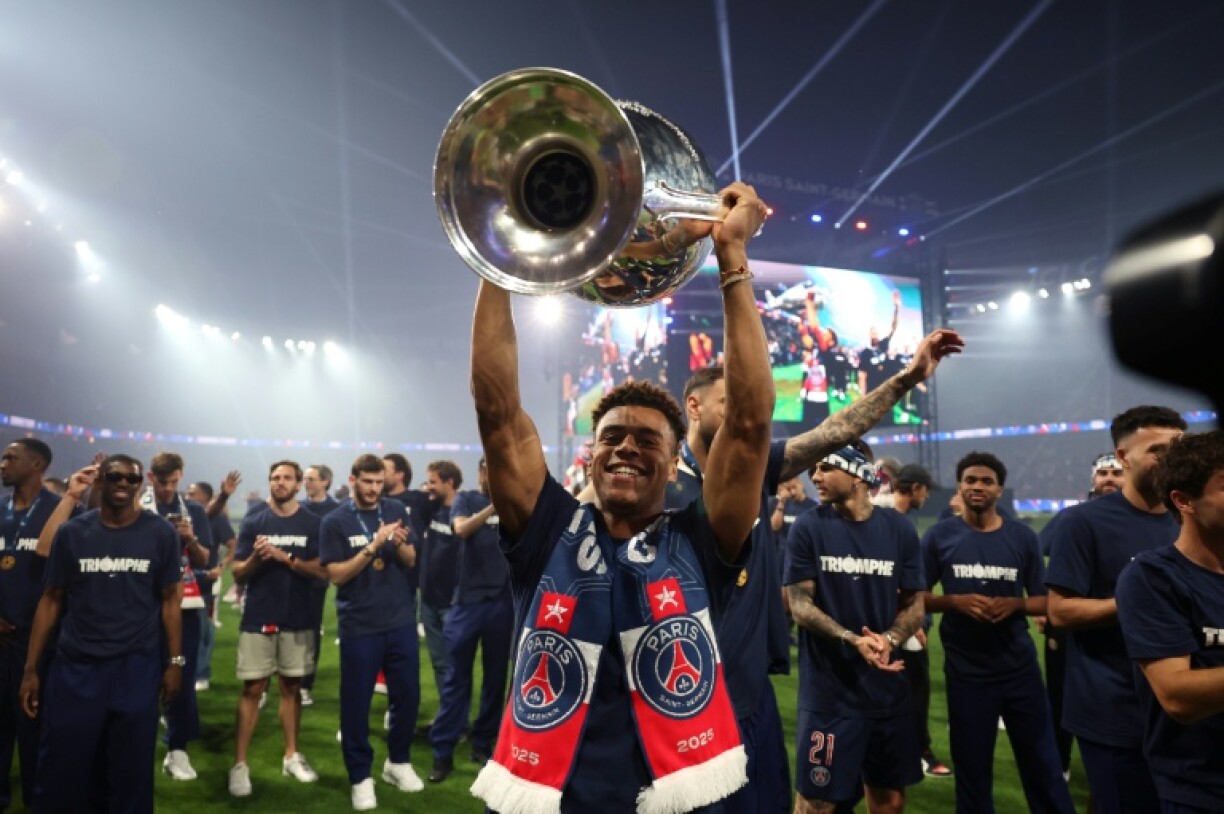 Paris Saint-Germain's French forward Desire Doue celebrates their Champions League triumph