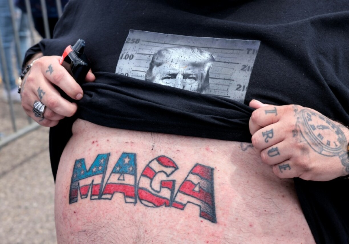 Casey Boeling shows his recently completed tattoo while waiting in line for an event with US President Donald Trump to commemorate his 100th Day in office