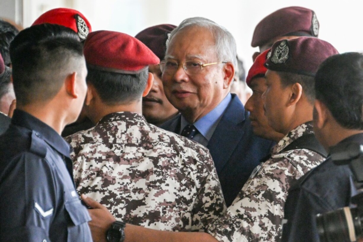 Former Malaysian prime minister Najib Razak (C) will begin his defence this week against more corruption charges, and appeal to have his sentence commuted to house arrest