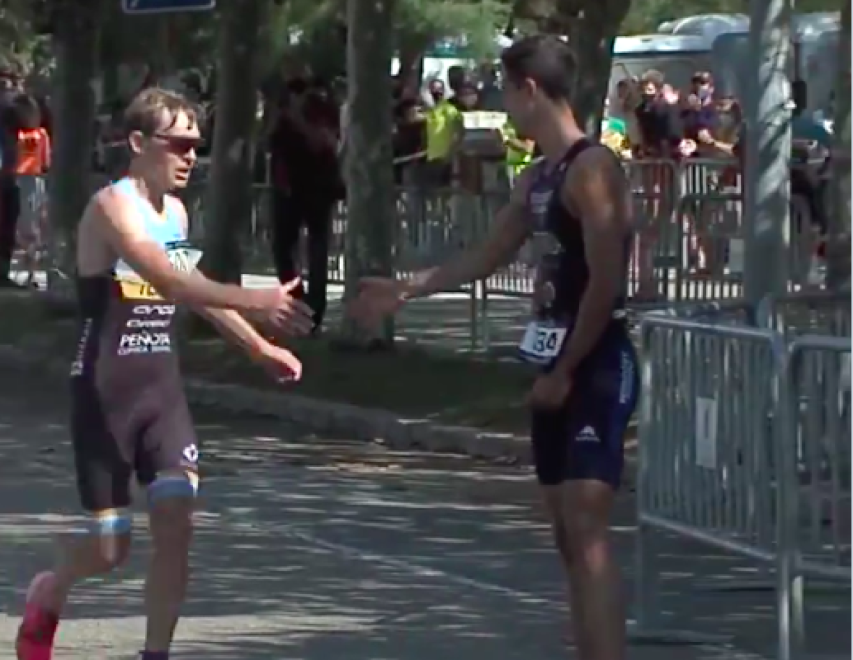 The two competitors shaking hands at the finishing line.