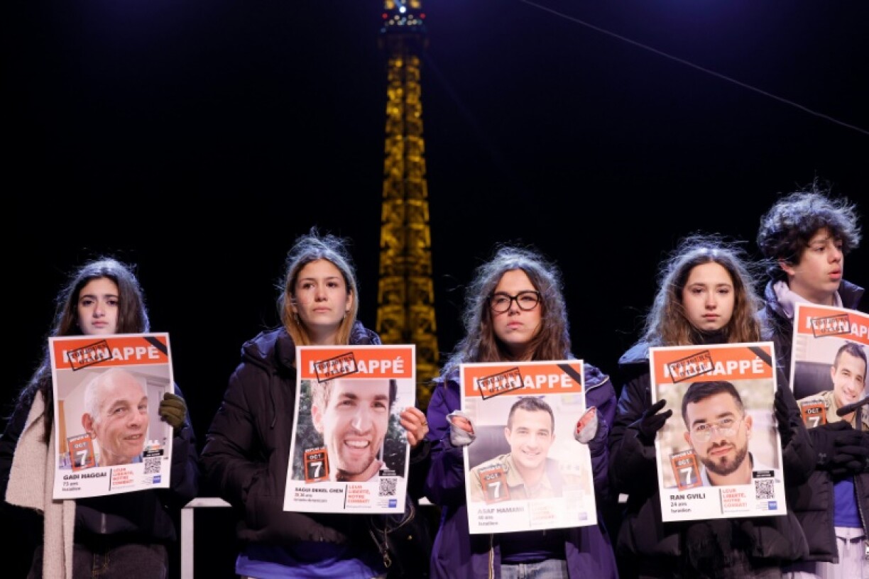 Some of those present carried photos of the hostages under a sign saying 'abducted'