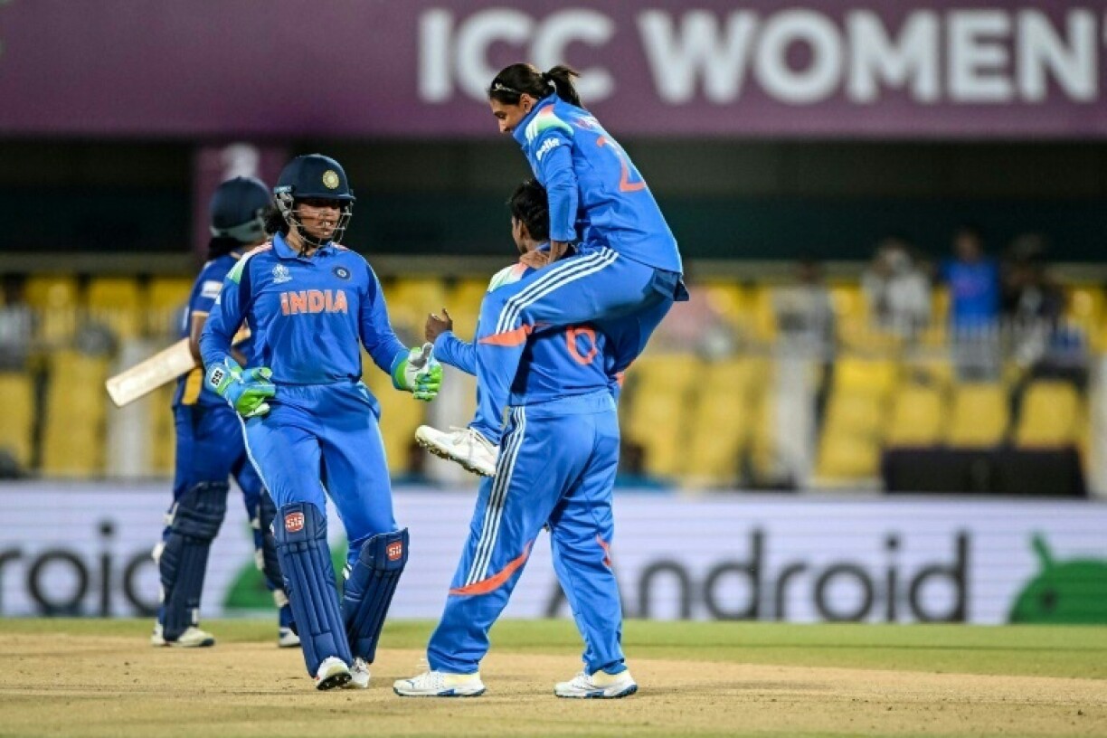 India's Deepti Sharma (C) celebrates with captain Harmanpreet Kaur (top)
