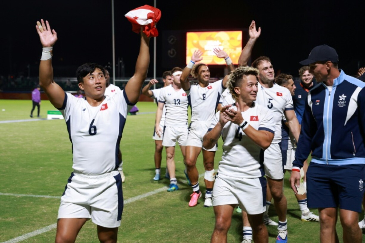Cado Lee (left) leads the Hong Kong players' celebrations after winning the Asian Games men's rugby sevens for the third time in a row